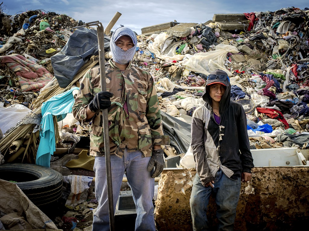 A father and son work together sorting garbage in the trash dump of Masaya, Nicaragua. It is common for the entire family to work together; meaning this health risk will exist for generations. Photo by: Timothy Bouldry, 2015. 